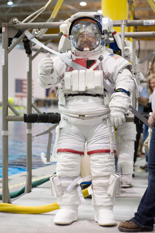 Japanese astronaut Furukawa gives a thumbs up to the camera while wearing an EVA spacesuit during training at NASA