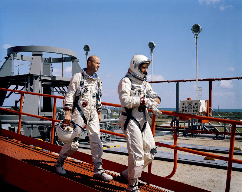 Astronauts Stafford and Schirra walk away from Pad 19 after their original Gemini 6 mission is scrubbed