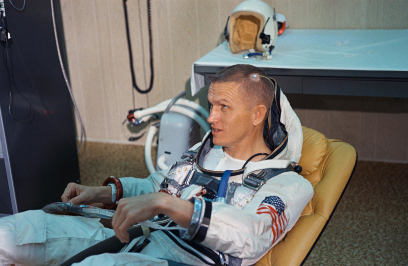 A seated Frank Borman during suiting up operations on launch day for Gemini 7