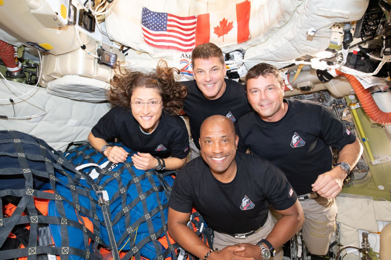 onboard image of the Artemis II crew posing together for the camera