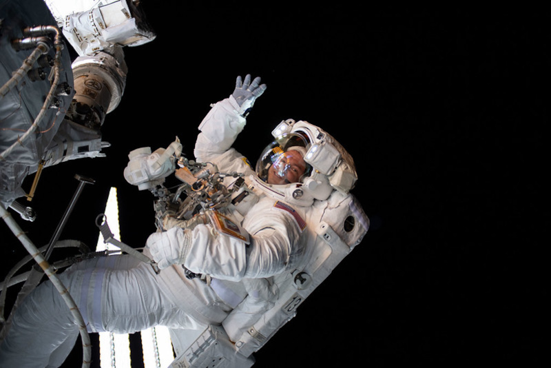 outside the ISS, Morgan waves at the camera during on of his seven EVAs