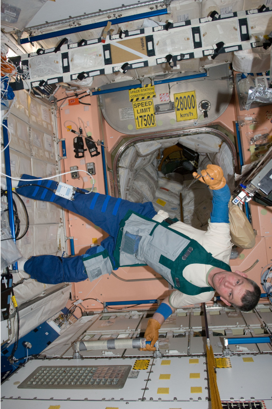 Samokutyaev in a work apron floating aboard the ISS