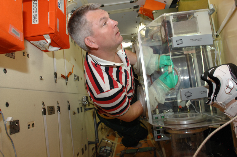 Samokutyaev works at a glovebox during his second space flight to ISS