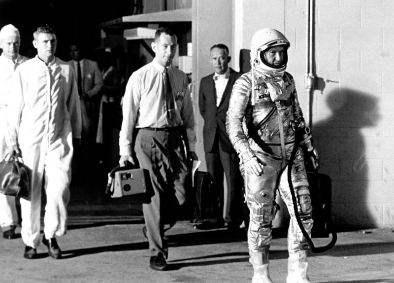 dressed in his silver spacesuit and carrying his ventilator, Schirra walks from the hangar at Cape Canaveral heading heading for the launch pad for his Mercury 8 mission
